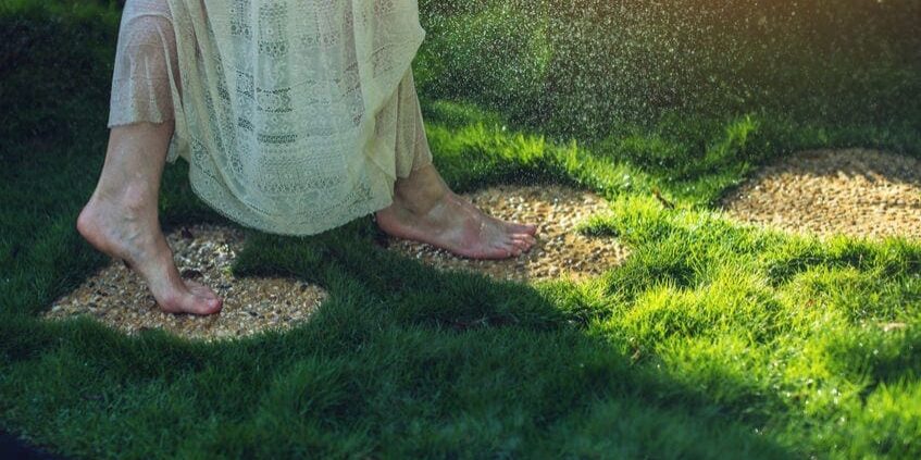 74306606_m 74306606 - girl walking barefoot on the stones in heart shape on green grass, concept of love for the nature