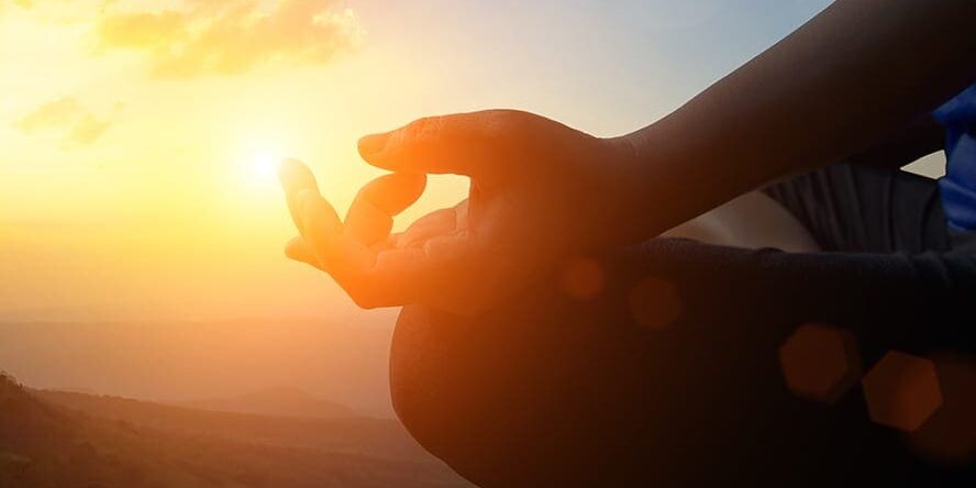 Young women meditate while doing yoga meditation. Young women meditate while doing yoga meditation, spiritual mental health practice with silhouette of lotus pose having peaceful mind relaxation on mountain outdoor with sunset golden heavenly sky.