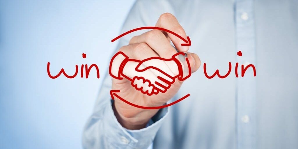 Win-win partnership strategy concept. Businessman draw win-win scheme and handshake partnership agreement.