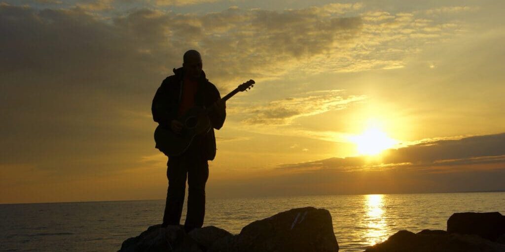lonely guitarist on the evening beach and sundown https://thesoulmedic.com/wp-content/uploads/./iStock-160108290-scaled.jpg