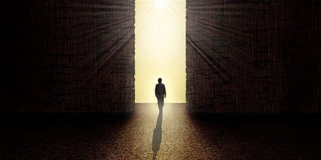 36900490 - man walking towards the light from darkness 36900490 - man walking towards the light from darkness